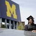 A UM graduate poses for a picture outside Michigan Stadium after Spring Commencement on Saturday, May 4. Daniel Brenner I AnnArbor.com